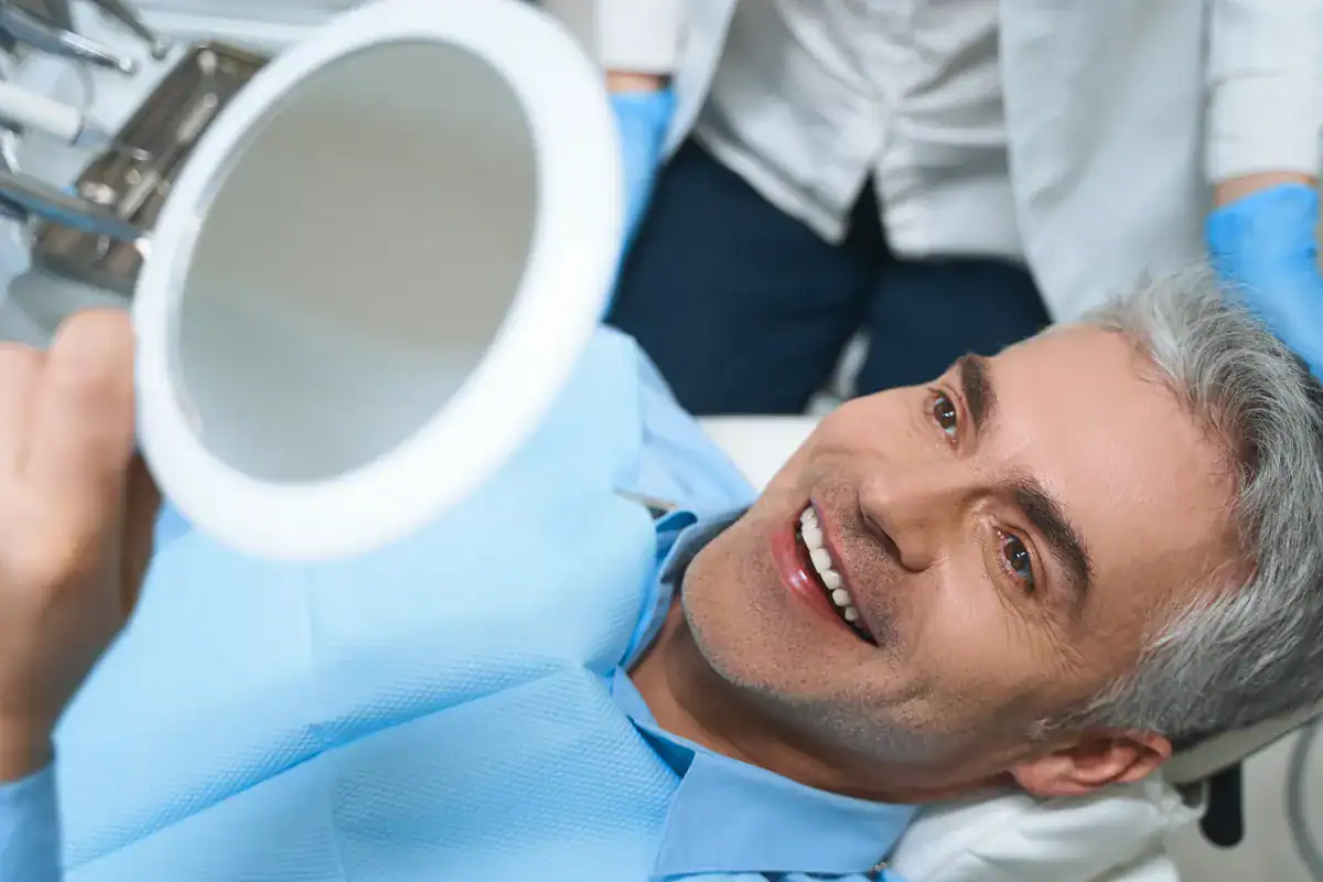 A smiling man receiving dental care