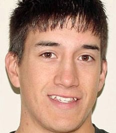 A smiling young man with crowding issues