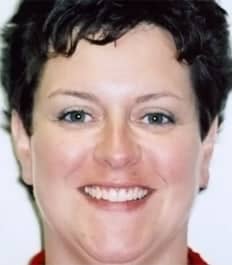 A smiling woman with short dark hair and healthy teeth