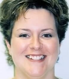 A smiling woman with short hair, close-up portrait